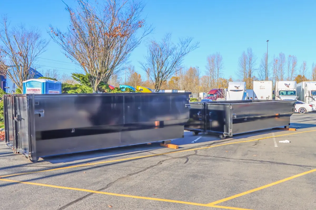 Professional dumpster rental service with roll-off container on residential driveway in Vestal